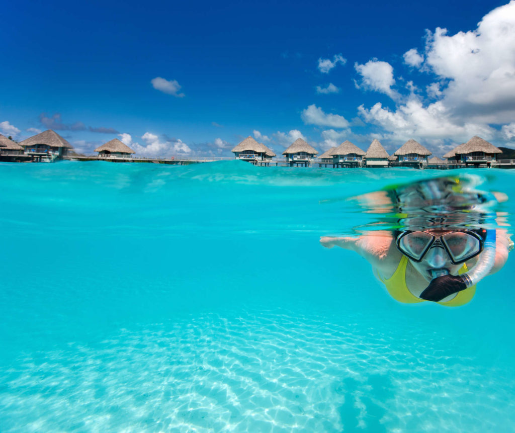 woman snorkelling half underwater angle